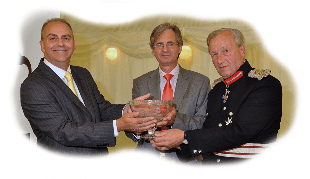 Ian Dennis and Graham Boswell accepting a crystal bowl commemorating the Queen's Award for International Trade 2011
